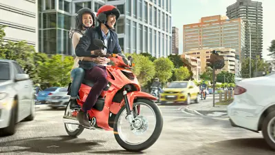 A couple riding an ICE vehicle on the city street